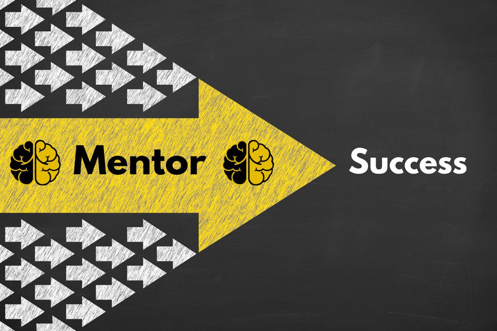 On a blackboard, a large yellow arrow labeled "mentor" is followed closely by a large group of smaller white arrows.