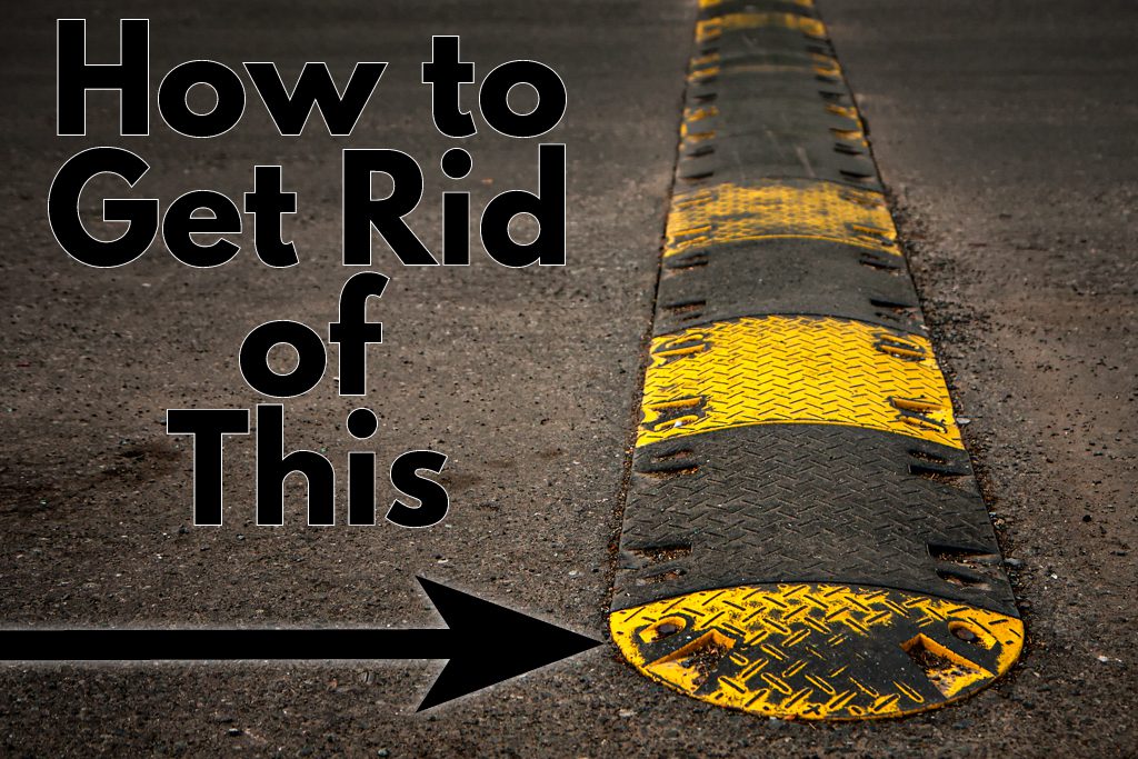 A black and yellow speed bump on asphalt with the words "How to Remove This" in black.