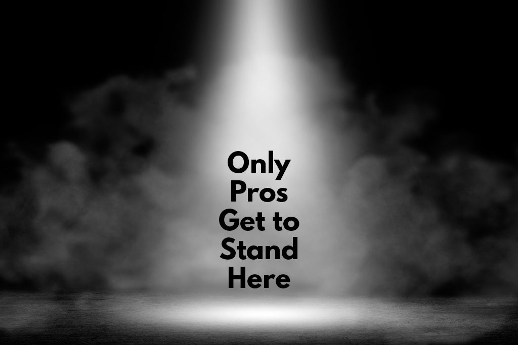 A white spotlight cuts through smoke on stage, with the words "Only pros get to stand here."