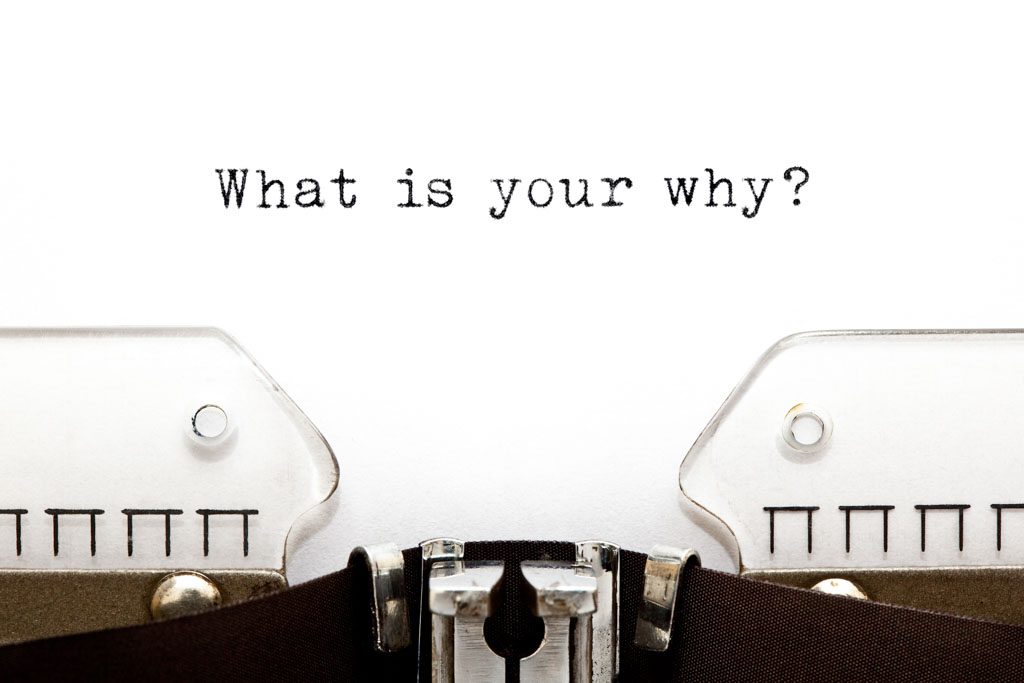 A piece of white paper in a typewriter with the words "what is your why?'