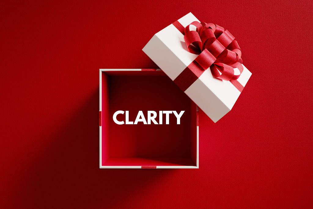 On a red background, a white gift box sits opened with the word "clarity" inside.