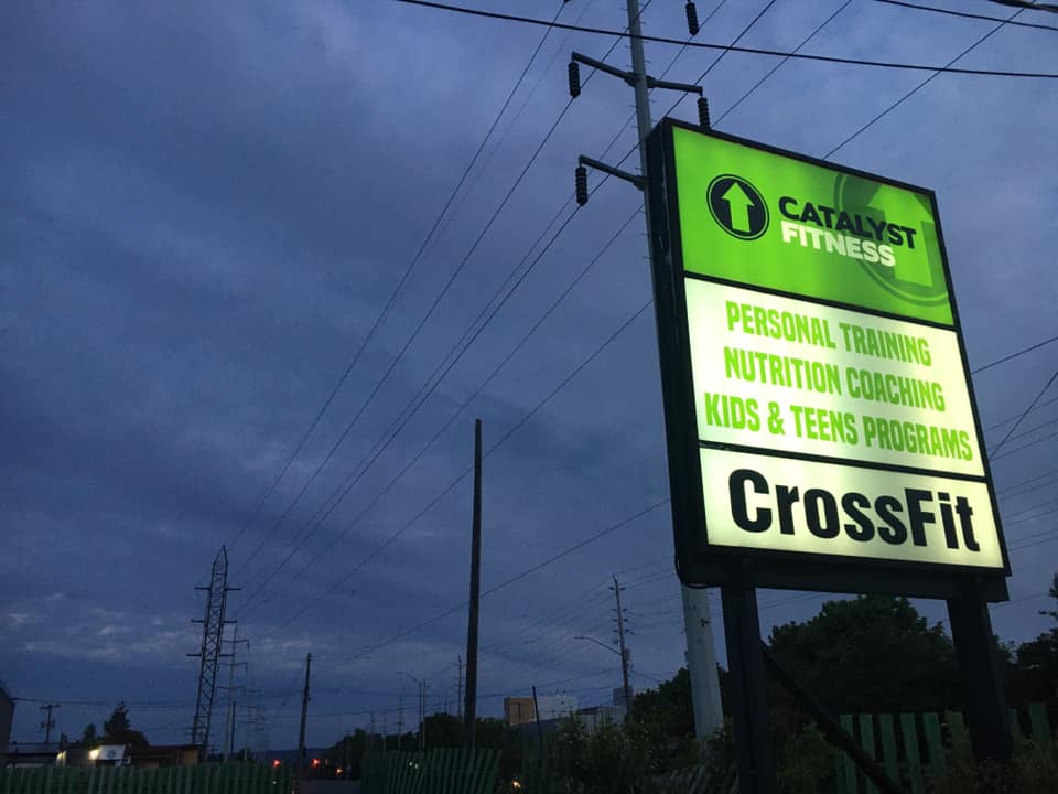 A green pylo sign in Sault Ste. Marie shows Catalyst Fitness and CrossFit before the gym deaffiliated.