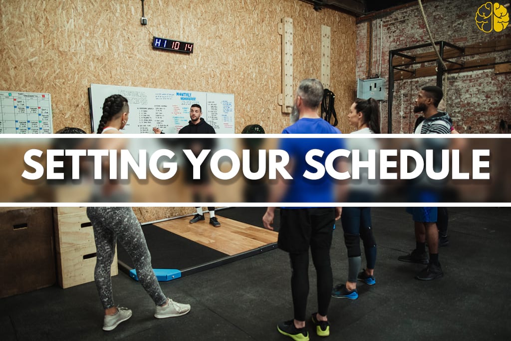 Gym goers looking at leaderboard - setting your schedule
