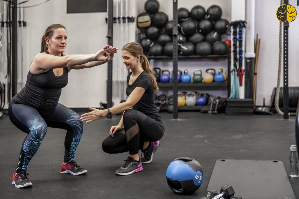 A trainer working with a pregnant client - Stop Losing Clients After Their First Session