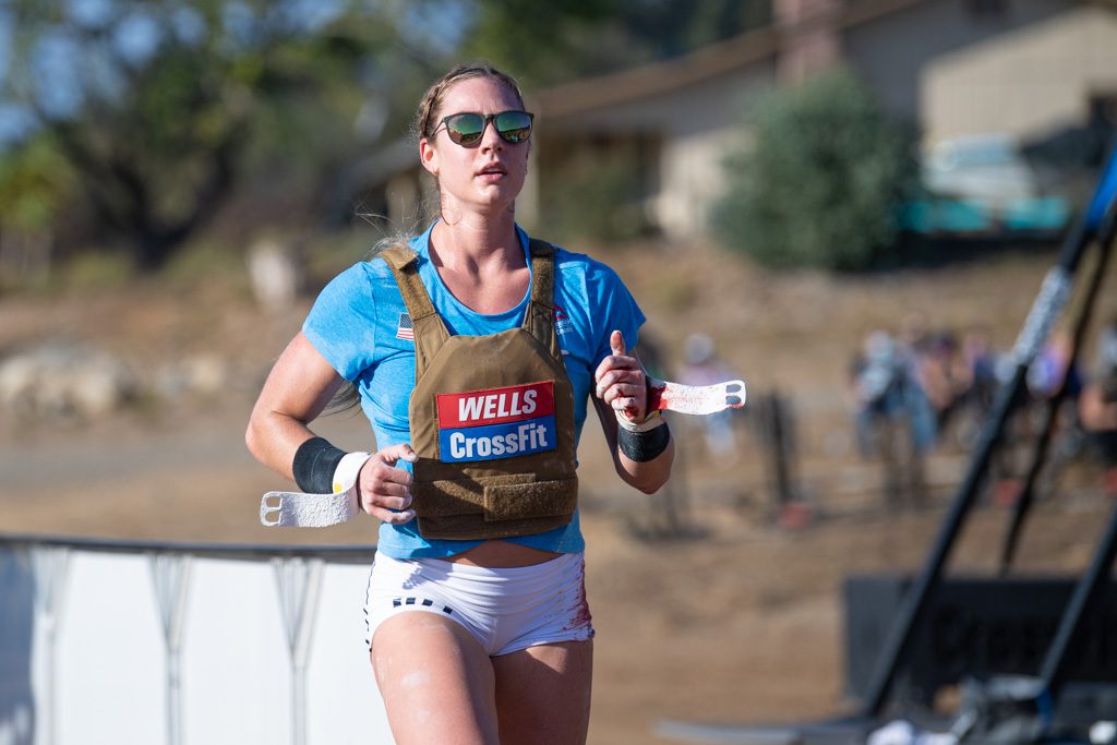 Brooke Wells runs in a weight vest with bloody hands at the 2020 CrossFit Games.