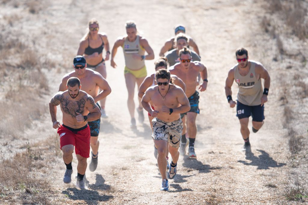 A group of athletes including Mat Fraser and Tia-Clair Toomey-Orr run at the 2020 CrossFit Games.