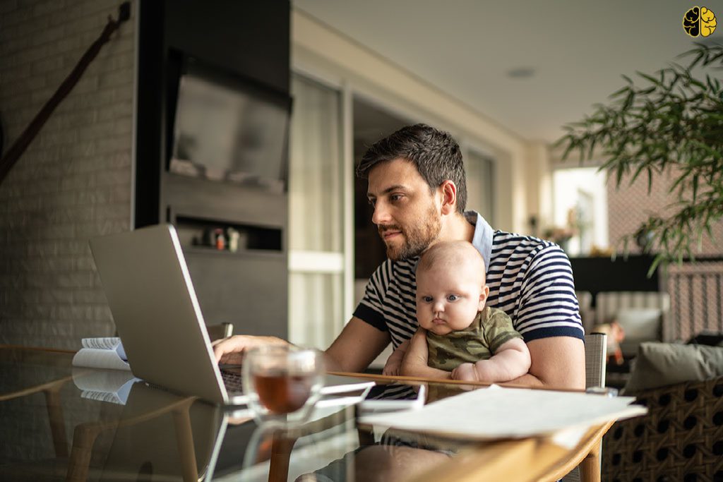 By the Numbers: The Gross Revenue Top 10 From April - a dad with a baby on his lap - doing finances