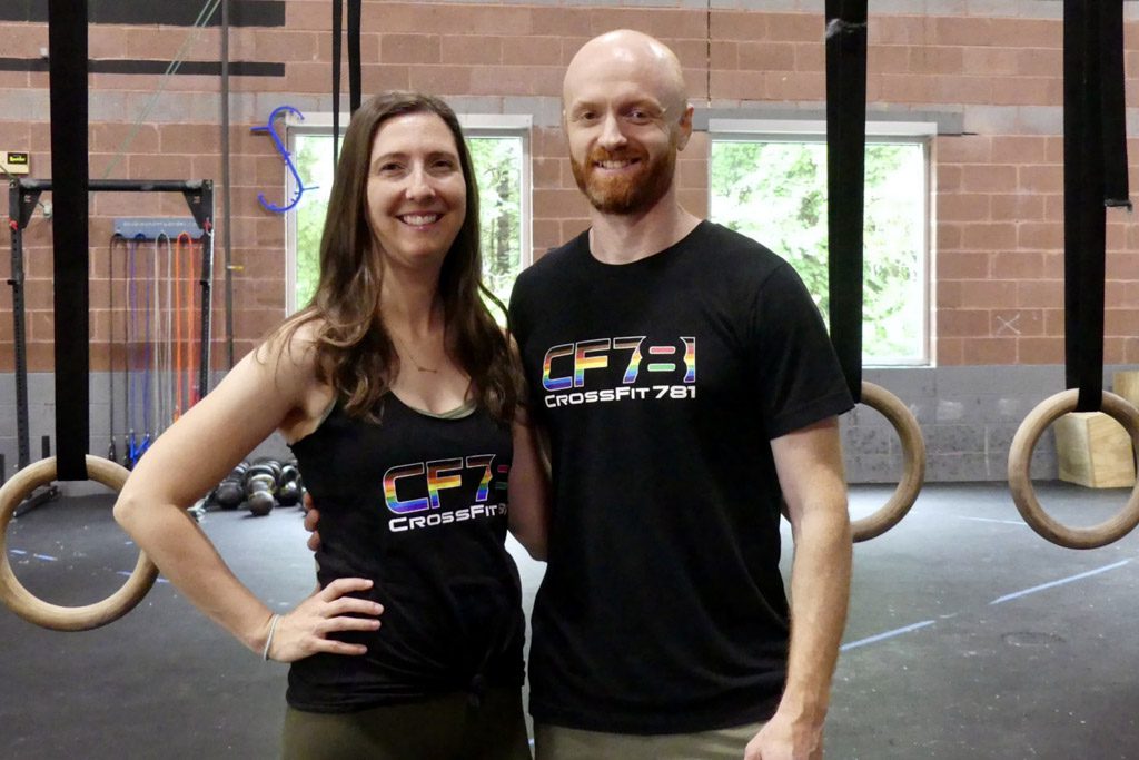 A portrait of Lesley and Eric Siegel standing in their gym.