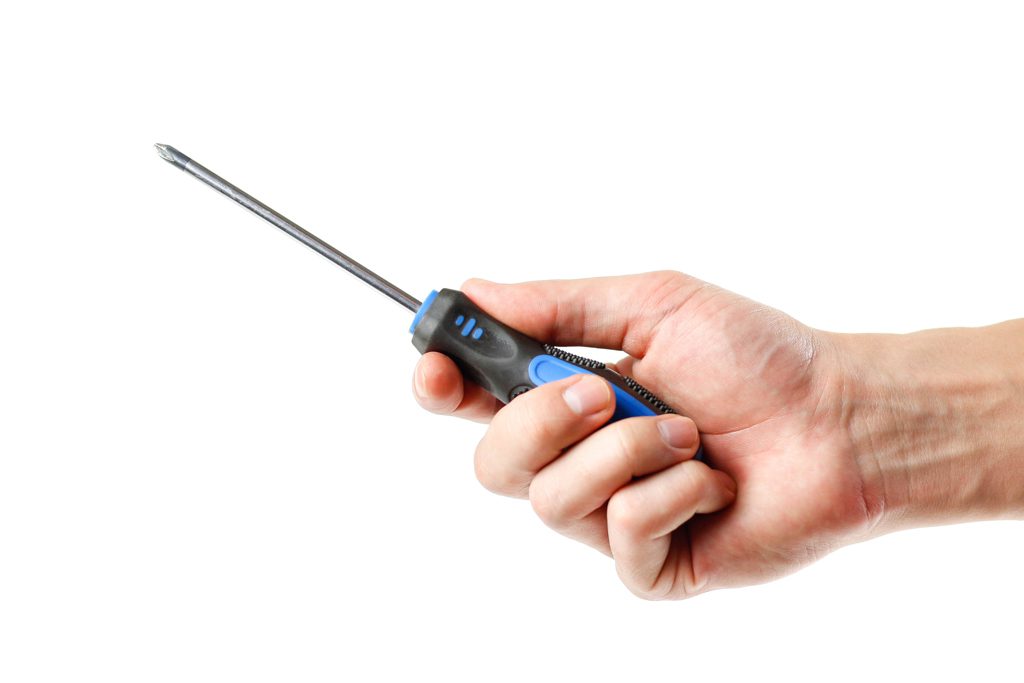 A closeup of a hand holding a screwdriver on a white background.
