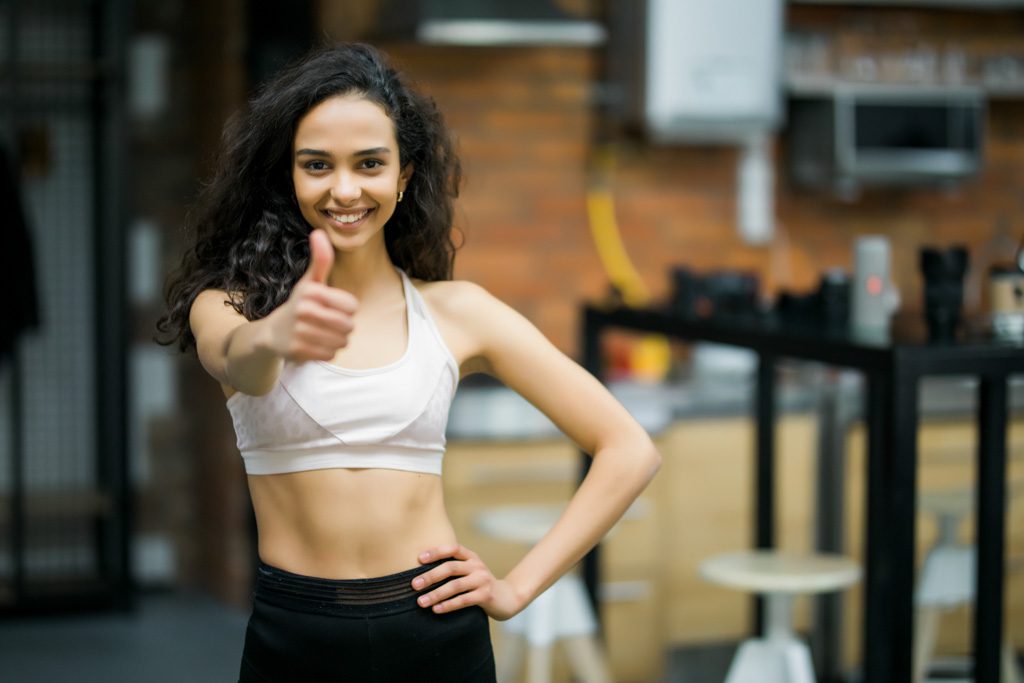A client gives the thumbs up to show readers are on track with starting a personal training business.