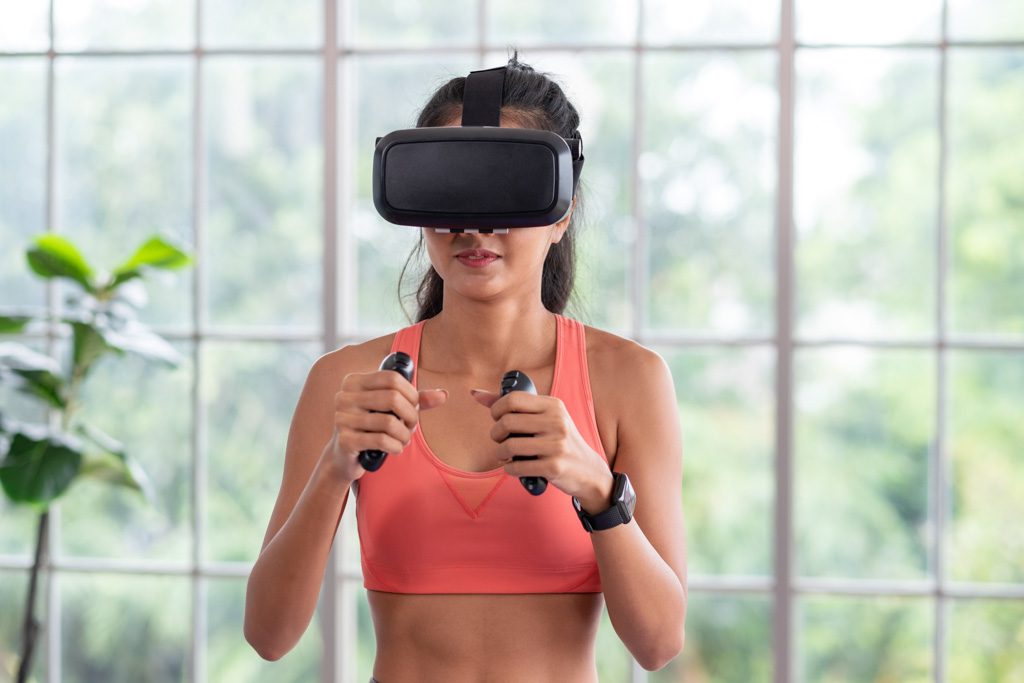 A woman watches an AI coach on a VR headset: A fitness industry analysis says this is increasingly common.