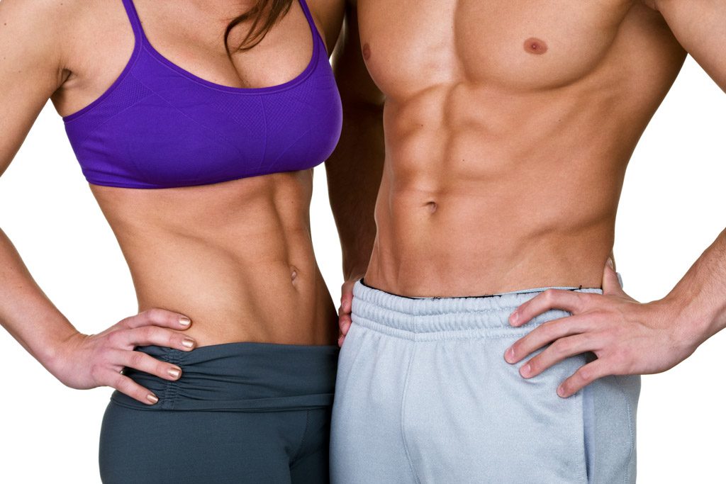 A closeup of a male and female athlete, each with well-defined abs.
