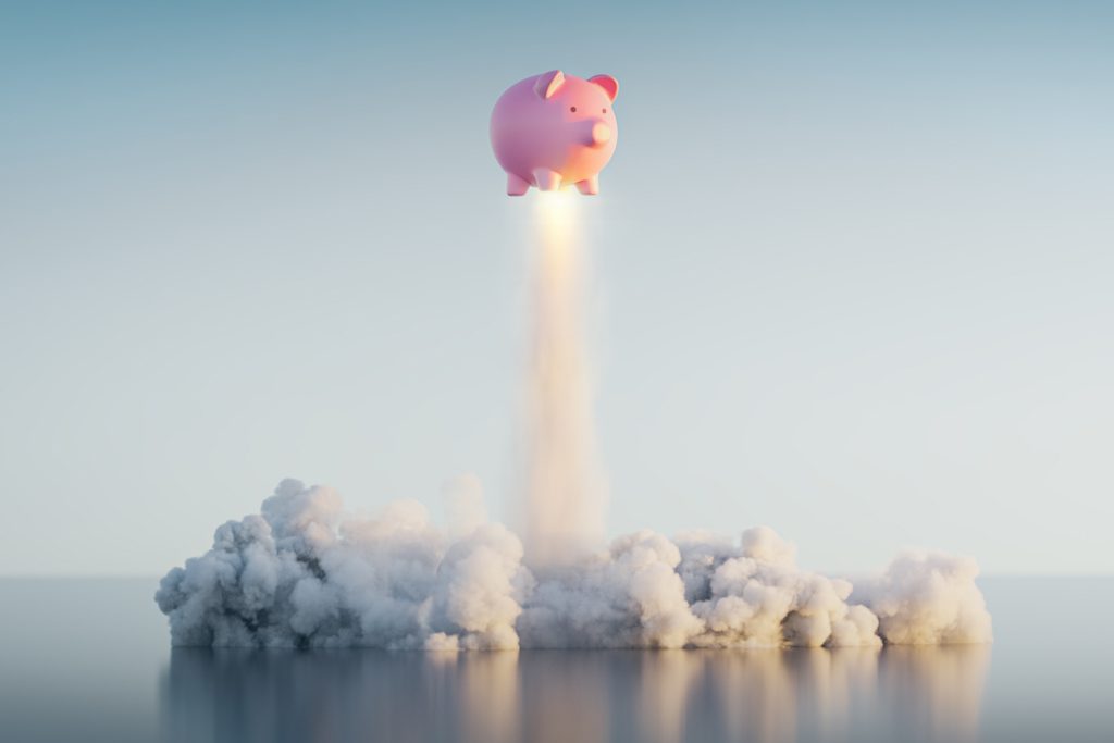 A piggy bank takes off like a rocket ship to demonstrate profit as a result of solid business practices.
