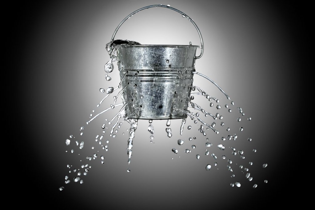 A leaky silver bucket drips water.