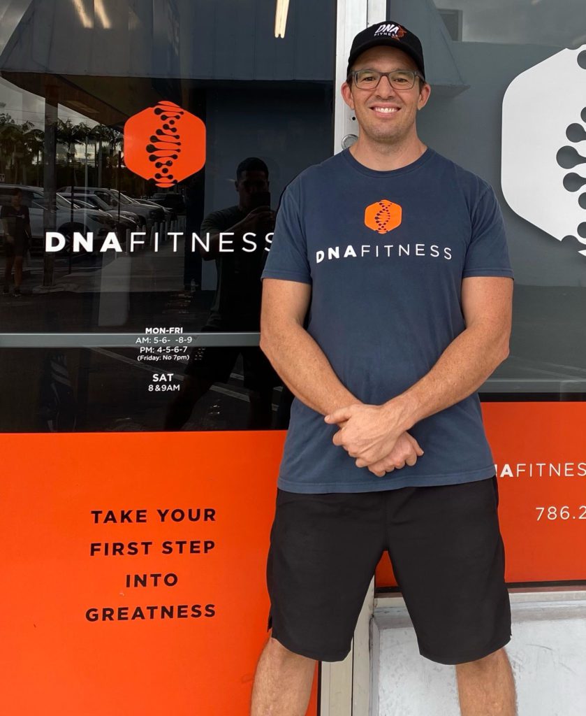 A portrait of business owner Adam Robbins standing in front of his gym.