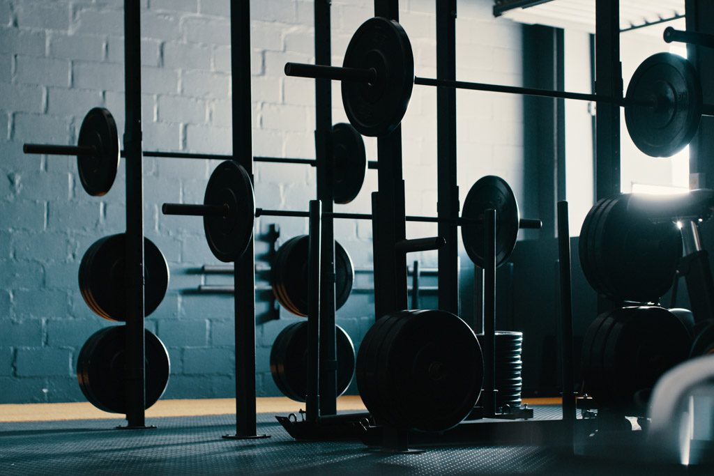 Squat racks and barbells as part of a gym's asset evaluation.