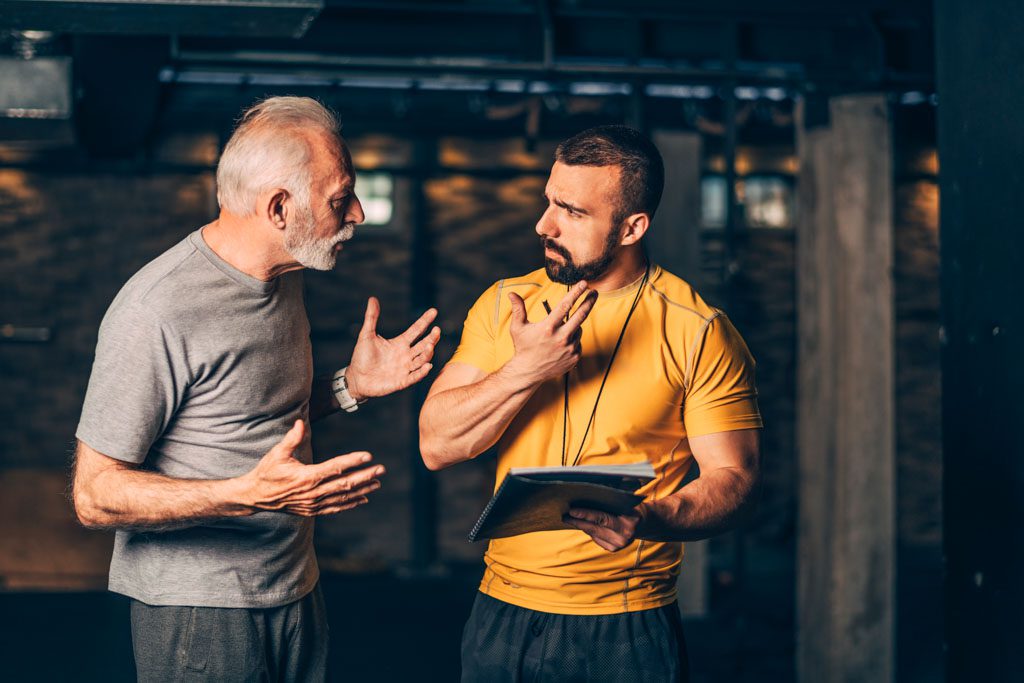 A gym owner argues with a staff member.