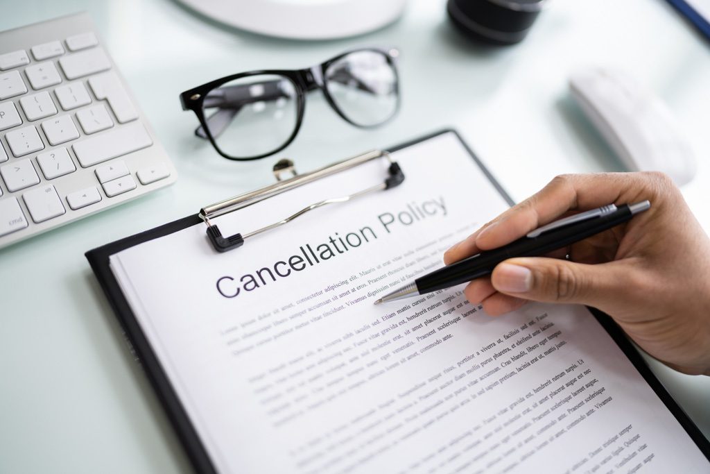 A closeup photo of a piece of paper with "cancelation policy" on it.