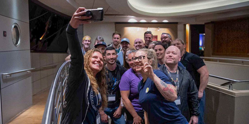 A group of happy clients take a selfie with mentor Anastasia Bennett at the 2022 Two-Brain Summit.