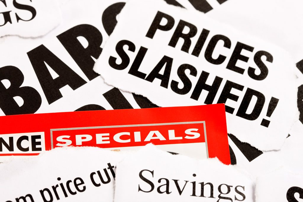 A closeup image of various signs offering discounts and specials.