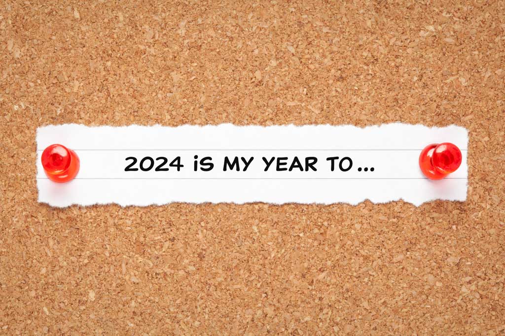 A scrap of paper on a pin-up board that reads "2024 is my year to..."