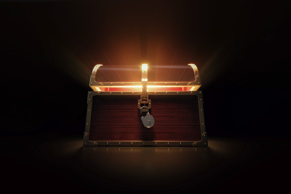 A glowing, partially open treasure chest on a black background.
