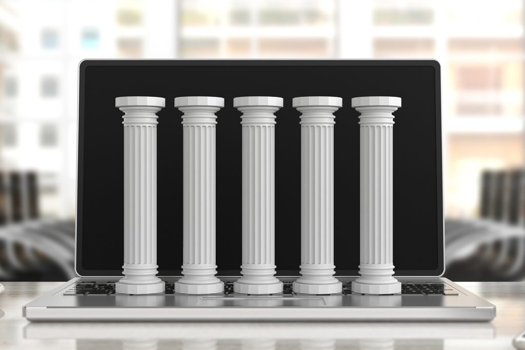 A laptop displays an image of five classical architectural pillars.