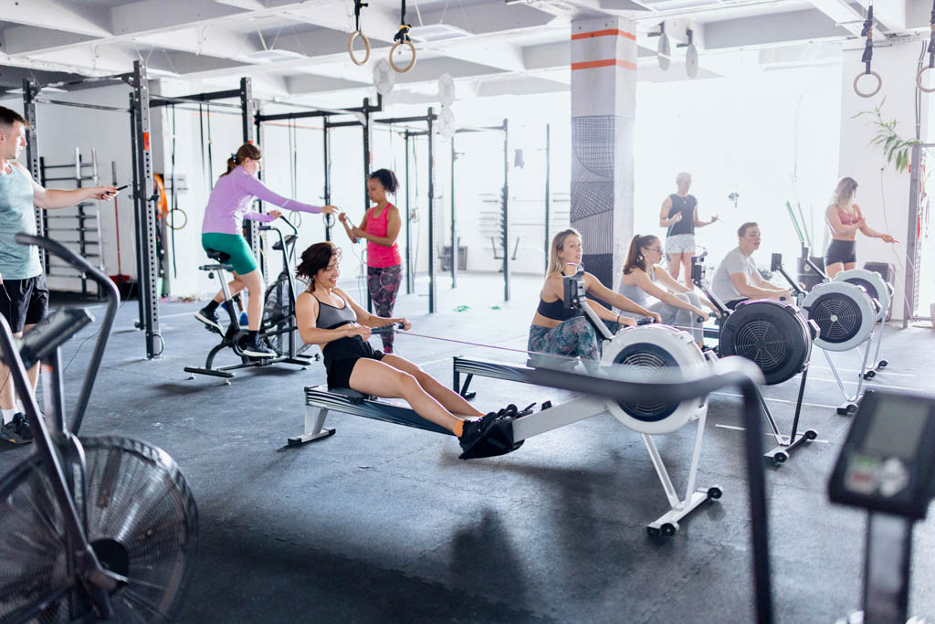 A large number of clients work out at a functional fitness gym.