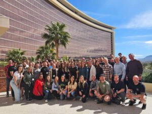 A large group of top gym owners posed in front of a Las Vegas hotel as part of a Two-Brain Tinker event.