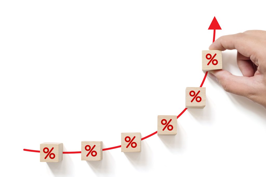 On a white background, a series up wooden blocks show increasing percentages to indicate improving sale value.