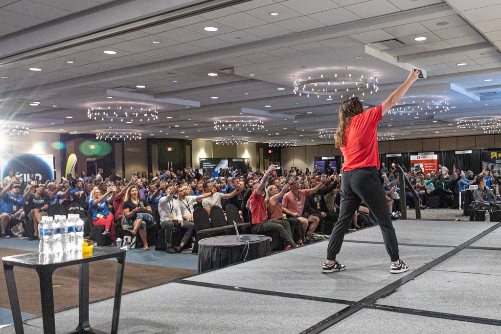Two-Brain Business mentor Kourtney Brownlow takes a selfie with a crowd of gym owners at the Two-Brain Summit in 2024.