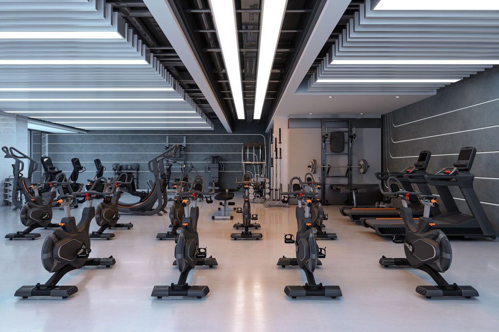 A photo of a large, empty gym filled with exercise equipment.