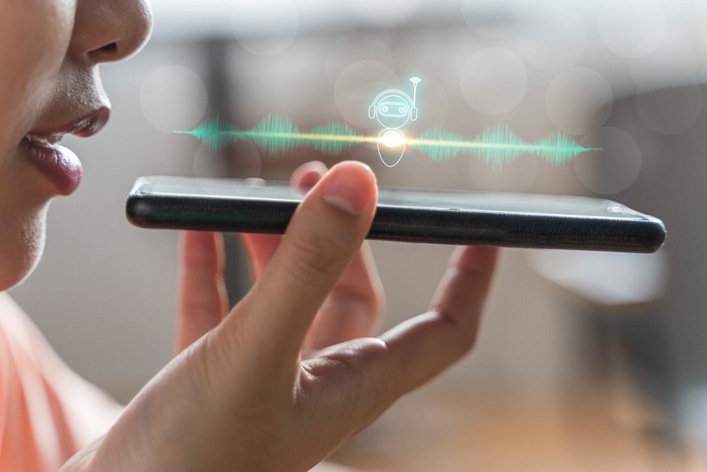 A closeup image of a woman recording herself speaking into a cell phone.