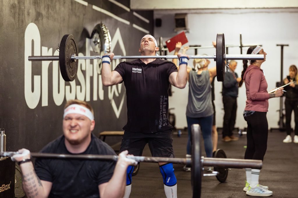 A photo of Ivan Racic doing a thruster at CrossFit XV in Croatia.