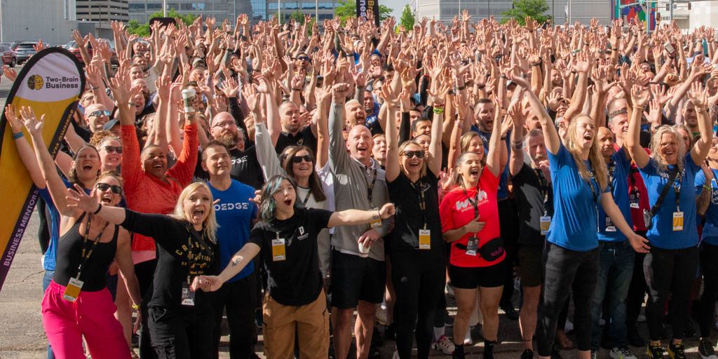 A huge group of gym owners cheer at the Two-Brain Summit in Chicago.