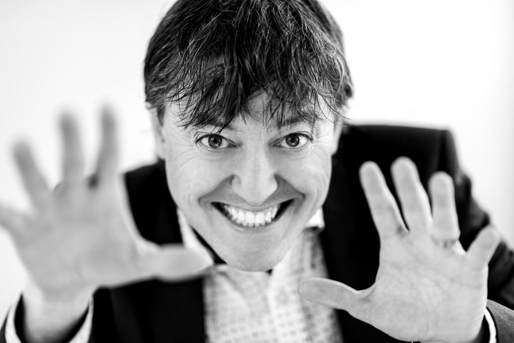 A black and white portrait of author Joey Coleman.