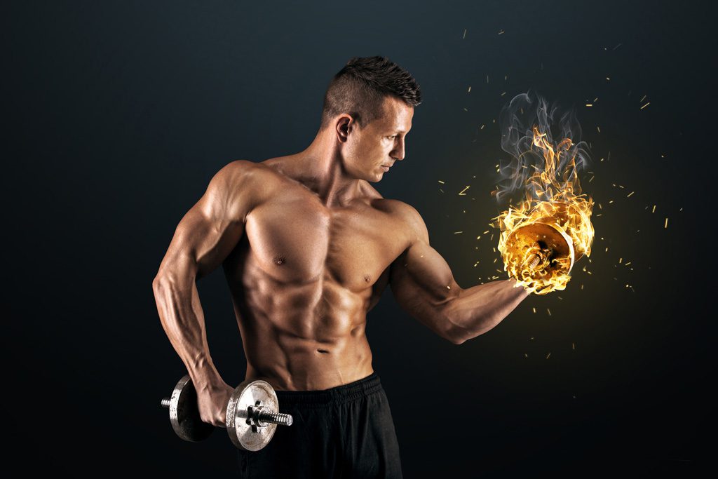 A muscular man does a biceps curl with a flaming dumbbell.