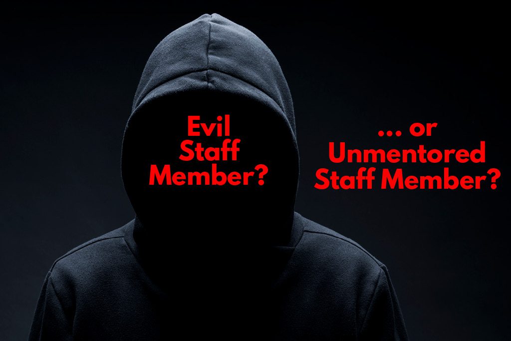 A faceless gym employee in a black hoodie with the text "evil staff member?"