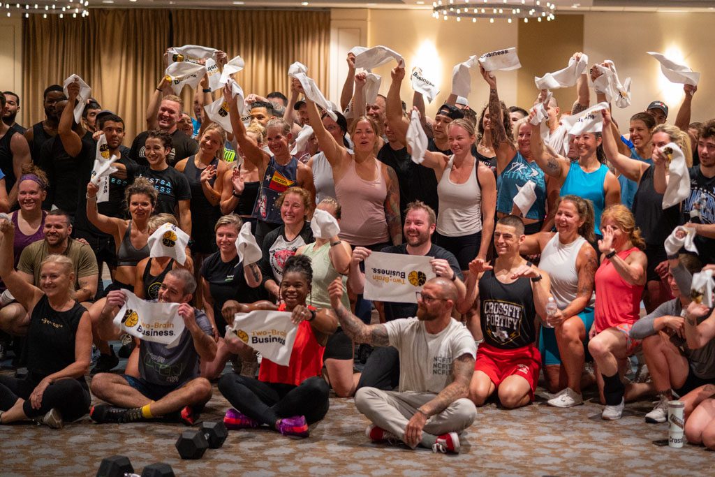 Gym owners cheer after a workout at the Two-Brain Summit.