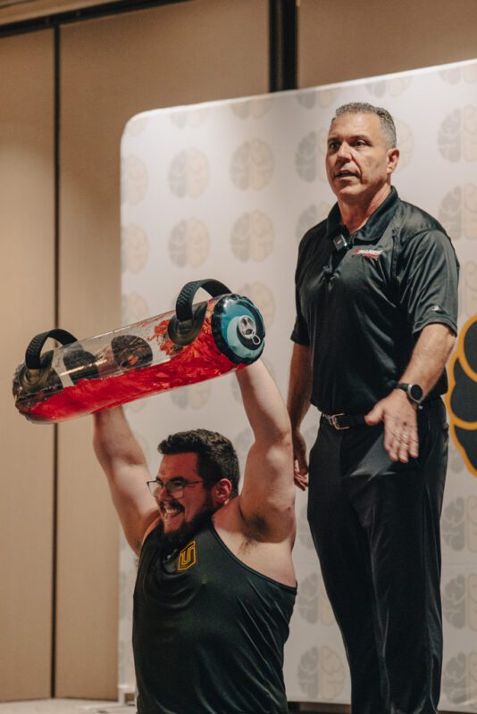 Bill Parisi uses a Tidal Tank with a gym owner at the Two-Brain Summit.
