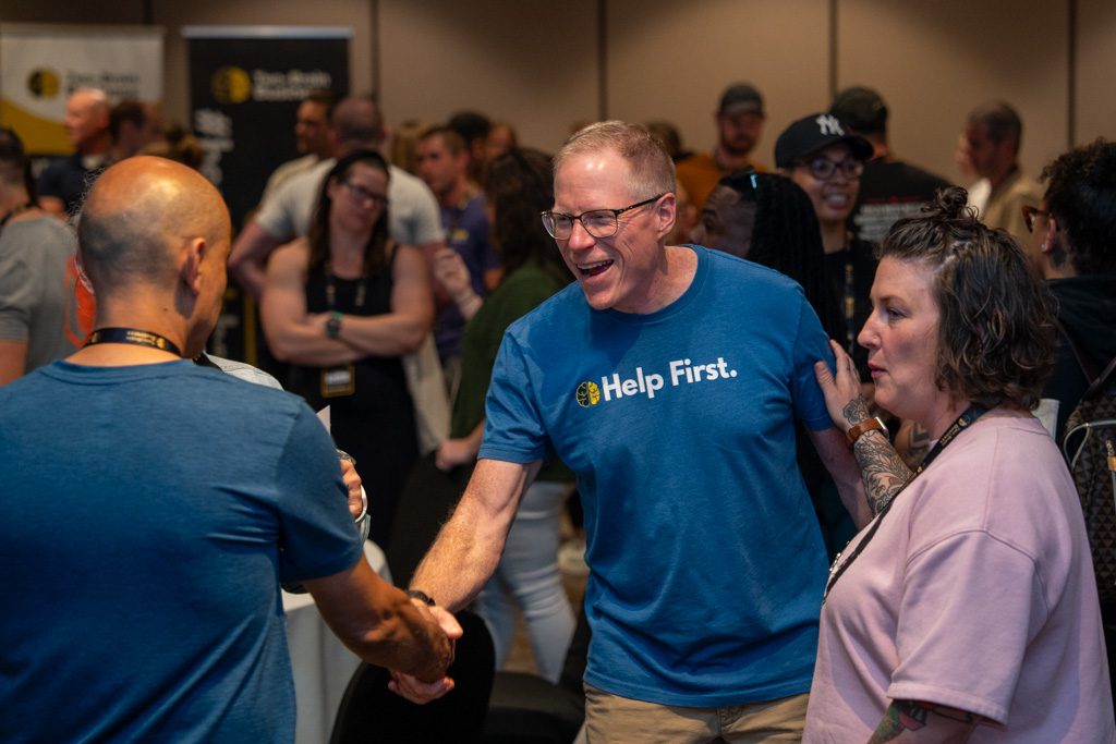 Chris Cooper greets gym owners at the Two-Brain Summit.