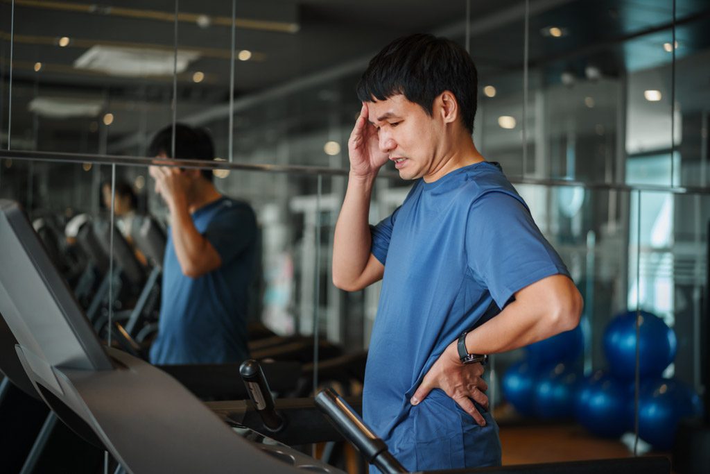 A clearly frustrated gym owner shakes his head.
