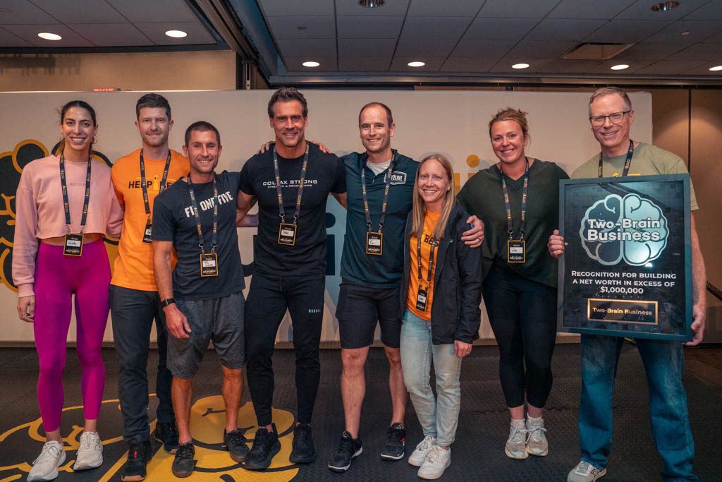 A group of millionaire gym owners poses at the 2025 Two-Brain Summit.