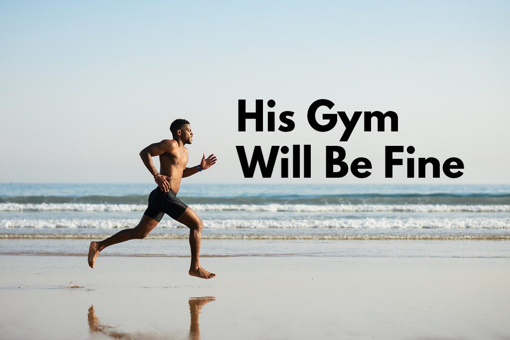 A fit gym owner runs along the beach while on vacation.
