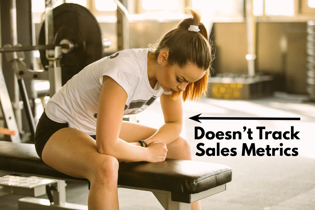 A depressed gym owner sits on a bench, with the caption "doesn't track sales metrics."
