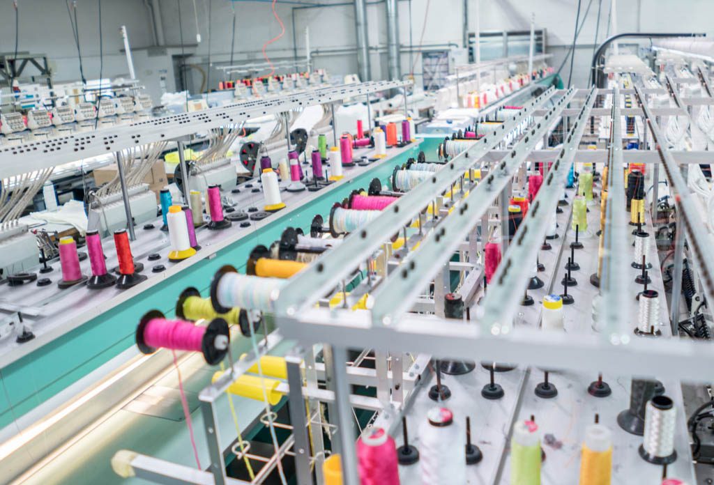 Machines that are part of the production line for embroidery in a clothing factory.