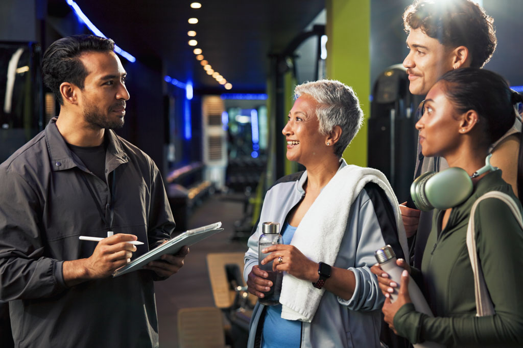 A gym owner meets with a group of prospective clients to close the sale.