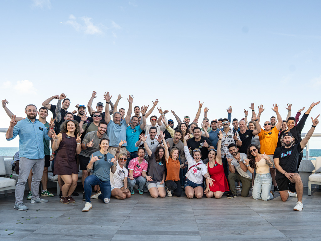 A large group of happy gym owners pose outside a hotel in Fort Lauderdale.
