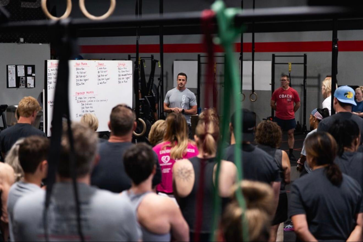 Gym owner Corey Lewis speaking to a crowd at his gym Xtra Mile Fitness